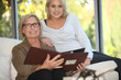 Grandmother and granddaughter looking at pictures