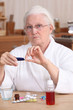 Elderly woman taking her medication