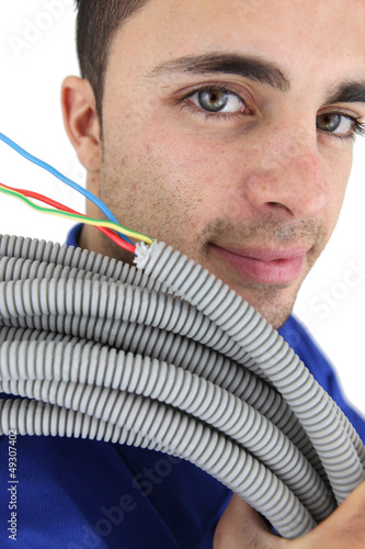 Photo: Electrician with a reel of wires Electrician with a reel of wires