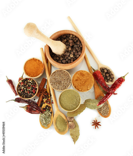 Photo: wooden mortar, bowls and spoons with spices isolated on white wooden mortar, bowls and spoons with spices isolated on white