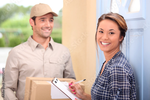 Photo: Delivery man and young woman Delivery man and young woman