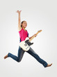 Photo: young woman playing on electro guitar and jumping young woman playing on electro guitar and jumping