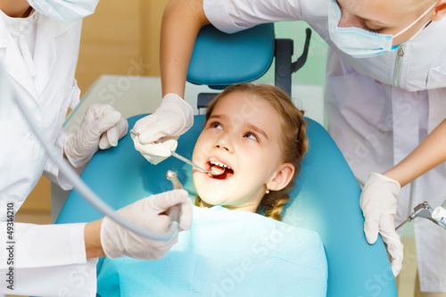 Photo: Little girl visiting dentist Little girl visiting dentist