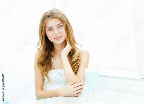 Photo: Young woman in cafe Young woman in cafe