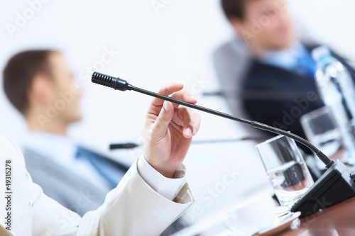 Photo: Hands of businessman holding microphone Hands of businessman holding microphone