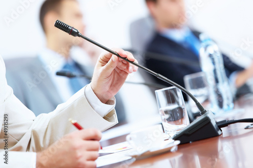 Photo: Hands of businessman holding microphone Hands of businessman holding microphone