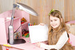 Cute little girl showing blank paper
