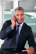 Businessman talking to his wife at the end of a workday