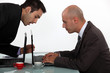 Businessman sneaking a peak at his colleague's work
