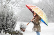 Foto: girl with colored umbrella standing in snowfall girl with colored umbrella standing in snowfall