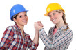 two craftswomen arm wrestling
