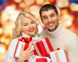 family couple in a sweaters with gift boxes