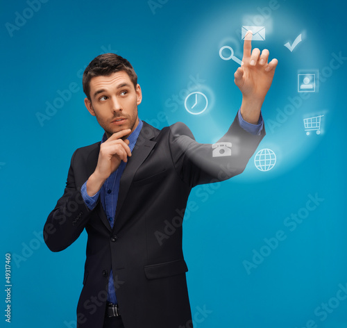 Photo: man in suit working with something imaginary man in suit working with something imaginary