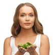 woman with spinach leaves on palms
