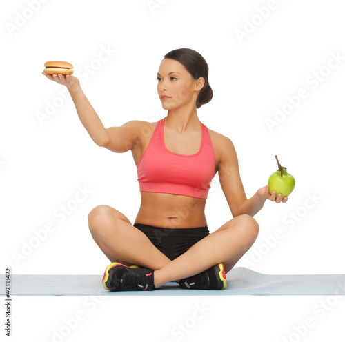 Photo: woman with apple and hamburger woman with apple and hamburger
