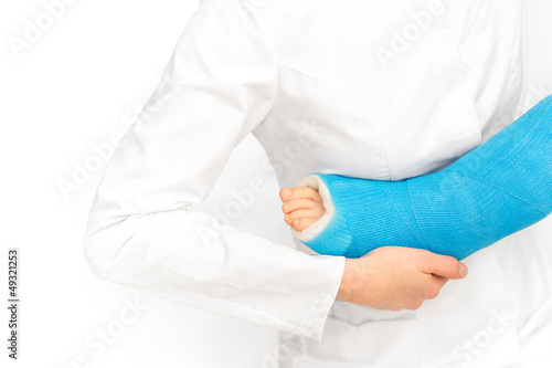 Photo: Caring nurse taking care of little broken leg of child Caring nurse taking care of little broken leg of child