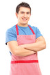 A portrait of a young male wearing apron and posing