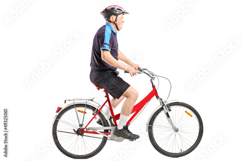 Photo: A senior bicyclist ridng a bicycle A senior bicyclist ridng a bicycle
