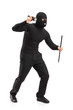Full length portrait of a robber with mask holding a flashlight