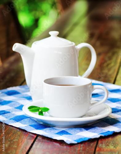 Photo: Cup of tea on wooden table Cup of tea on wooden table