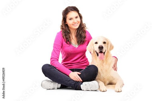 Photo: Young female posing with a retriever dog Young female posing with a retriever dog