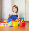girl plays with toys in home