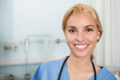 Front view of a nurse smiling while looking at camera
