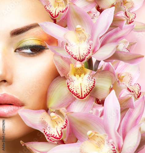  Beautiful Girl With Orchid Flowers. Beauty Model Woman Face