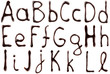 Big and small letters of the alphabet made from chocolate syrup