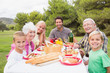 Portrait of multi-generation family at picnic table