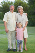 Grandparents standing with grandson