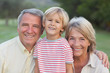 Portrait of grandparents with grandson smiling