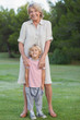 Smiling grandmother standing with grandson