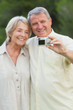 Older couple taking a photo of themselves