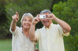 Couple taking a photo of something in the park