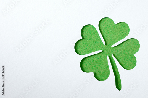 Photo: St. Patrick clover cut from paper. Greeting card. Paper craft. St. Patrick clover cut from paper. Greeting card. Paper craft.