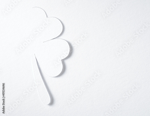 Photo: St. Patrick clover cut from paper. Greeting card. Paper craft. St. Patrick clover cut from paper. Greeting card. Paper craft.