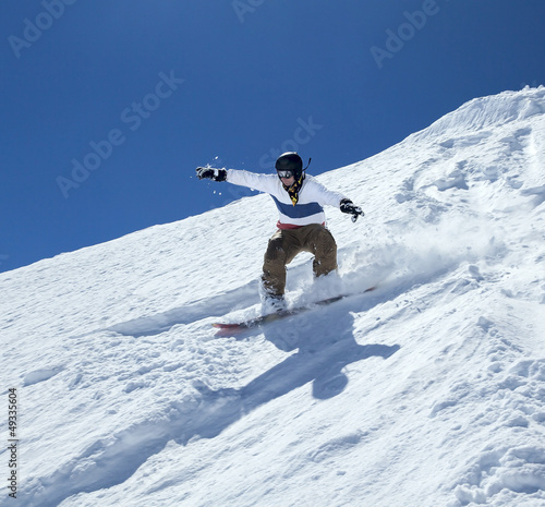 Photo: Snowboarder moving down Snowboarder moving down