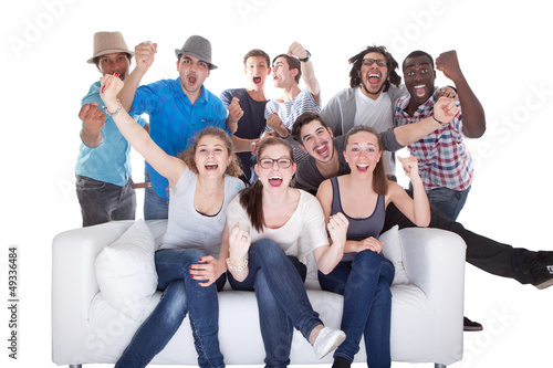Photo: Group Of Friends Enjoying Watching Television Group Of Friends Enjoying Watching Television