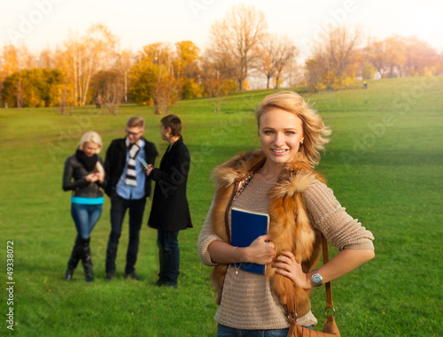 Photo: Beautiful blond student with friends Beautiful blond student with friends