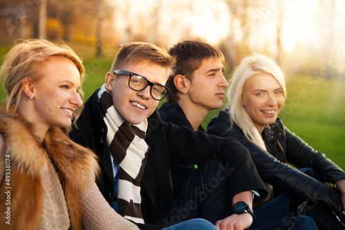 Photo: Four students sitting in the park Four students sitting in the park