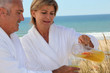 Mature couple drinking on beach