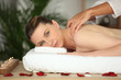 Young woman enjoying a rose scented back massage