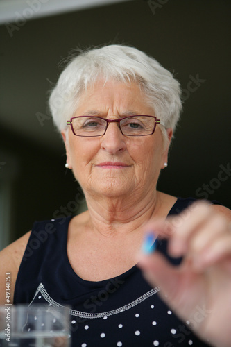 Photo: senior woman taking pills senior woman taking pills