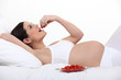 Pregnant woman eating tomatoes
