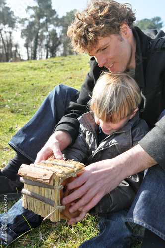 Photo: Family and son building an object Family and son building an object