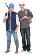 Tradesman standing next to  apprentice