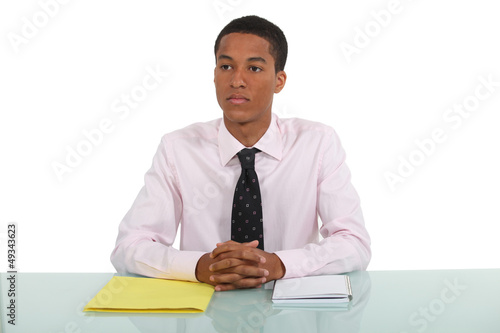 Photo: Man daydreaming whilst sat at his desk Man daydreaming whilst sat at his desk