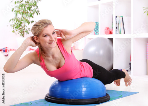 Photo: Beautiful middleaged woman doing fitness Beautiful middleaged woman doing fitness