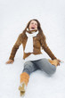 Young woman slipped on snow in winter park